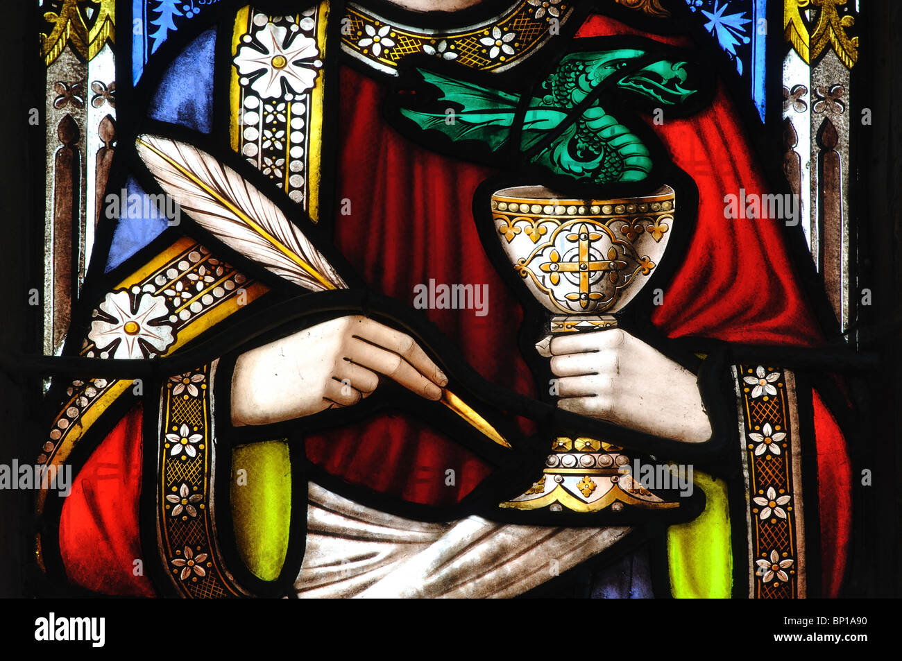 Saint John with quill and chalice stained glass in St. Gregory`s Church, Tredington, Warwickshire, England, UK Stock Photo
